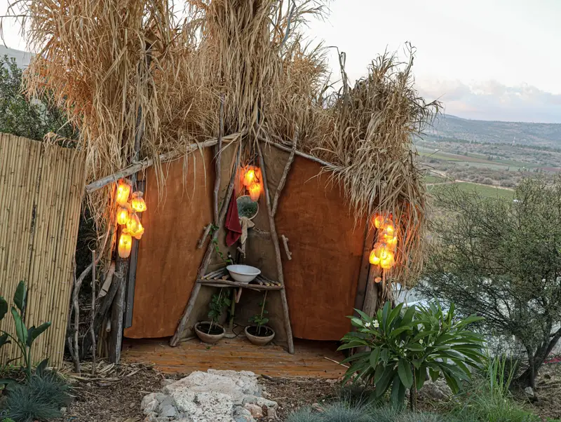 היורט מבחוץ בלילה, עם לפידים משני צדי הפתח
